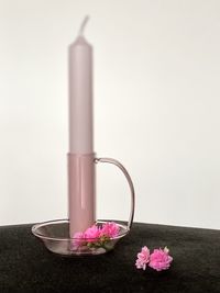 Close-up of pink flowering plant on table
