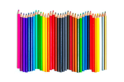 Multi colored pencils against white background