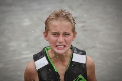 Portrait of happy young woman in water