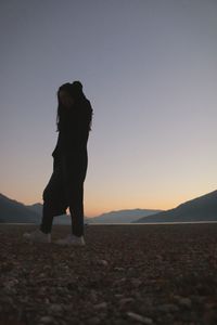 Woman on beach at sunset