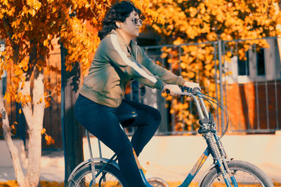 Close-up of woman cycling in the street