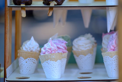 Classic cream in a row. variety of ice cream scoops in cones with chocolate, vanilla, strawberry 
