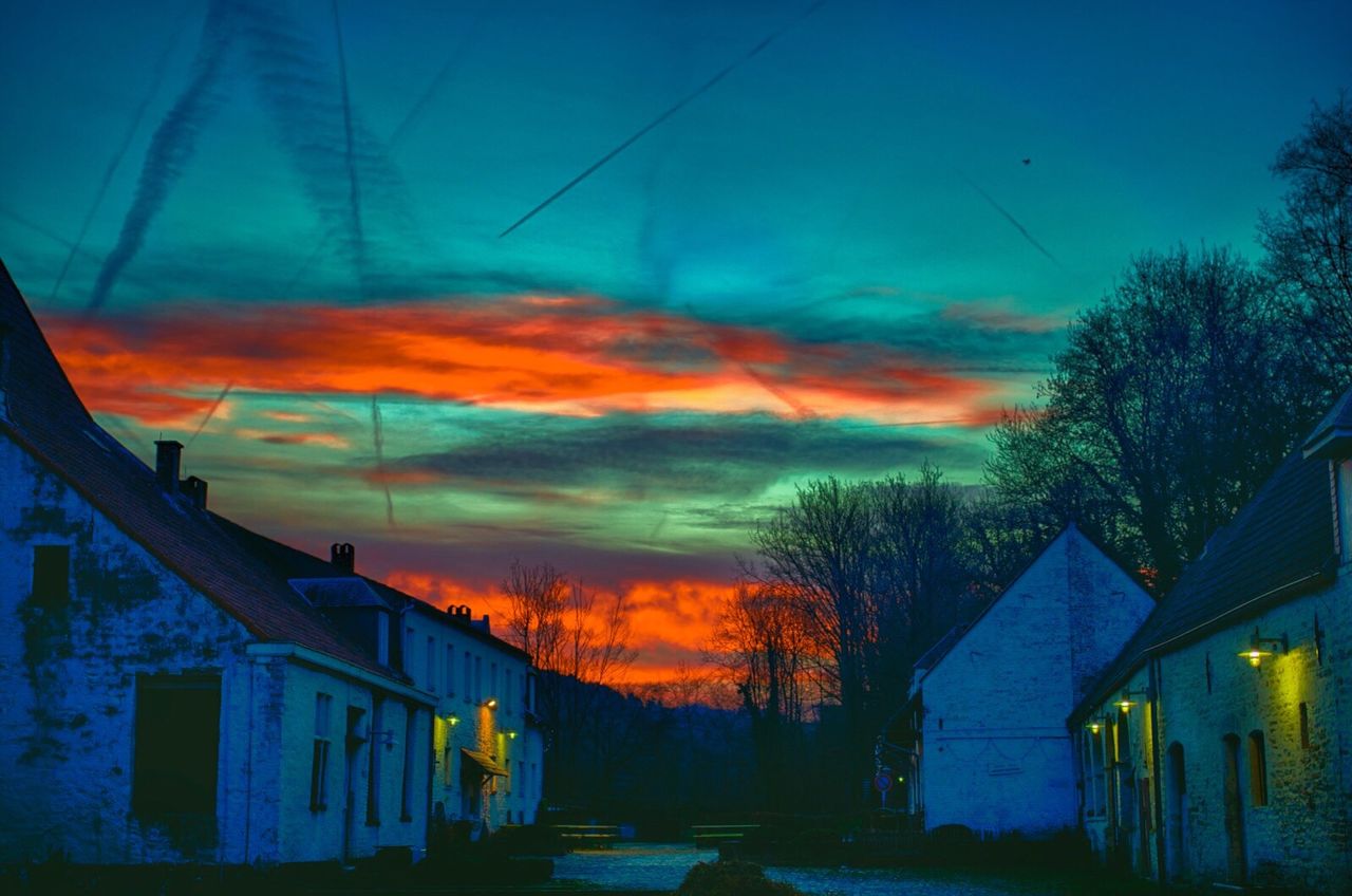 architecture, building exterior, built structure, sunset, house, sky, silhouette, residential structure, low angle view, tree, residential building, blue, orange color, dusk, building, cloud - sky, outdoors, no people, cloud, bare tree