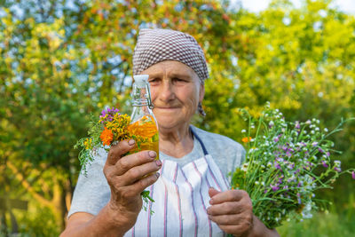 Close-up of hand holding flowers