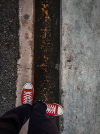 Low section of person standing by gutter