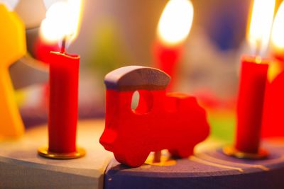 Close-up of illuminated red candles