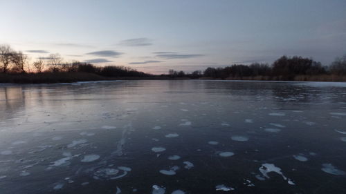 Scenic view of frozen lake against sky during winter