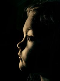 Side view of man against black background