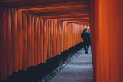 Rear view of man standing by building