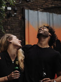 Rear view of couple looking at camera