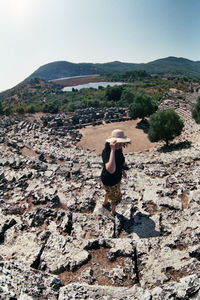 Rear view of man on mountain against sky