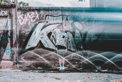 Digital composite image of woman with graffiti on water