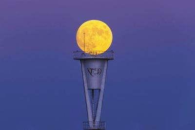 Low angle view of street light against clear blue sky