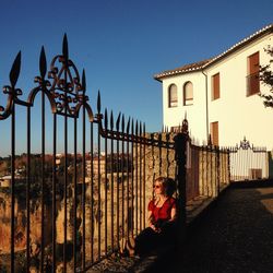 Man with umbrella against clear sky