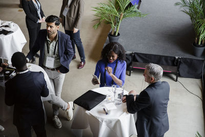 Business professionals discussing during seminar at conference center