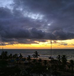 Scenic view of sea against dramatic sky during sunset