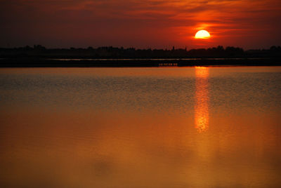 Scenic view of lake at sunset