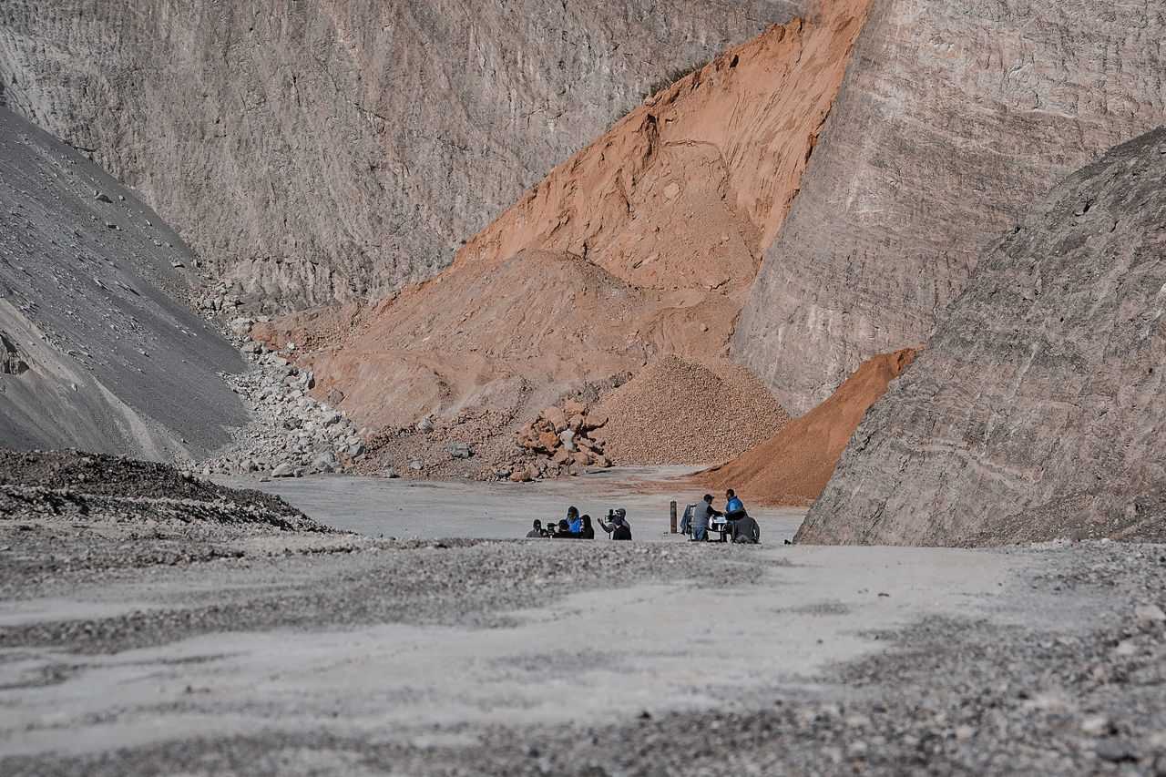 mountain, group of people, land, nature, scenics - nature, day, transportation, landscape, beauty in nature, lifestyles, environment, mode of transportation, leisure activity, real people, rock, travel, men, geology, land vehicle, people, outdoors, formation, climate, arid climate