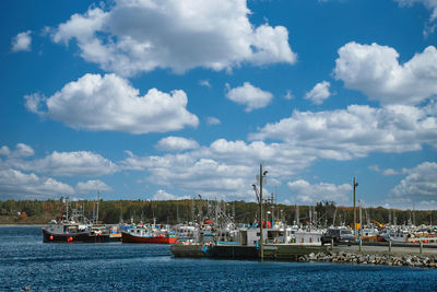 Boats in sea against sky