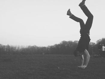 People walking on grassy field