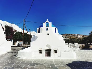 Low angle view of greek church against clear blue sky