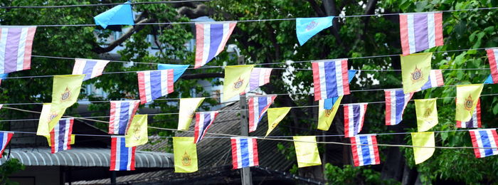 Close-up of multi colored flags hanging on clothesline