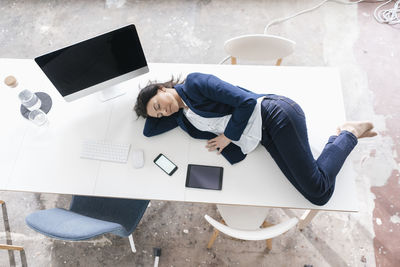 Businesswoman sleeping on desk in the office