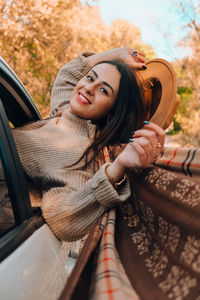 Portrait of young woman in car