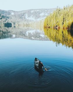 High angle view of man rowing boat at lake