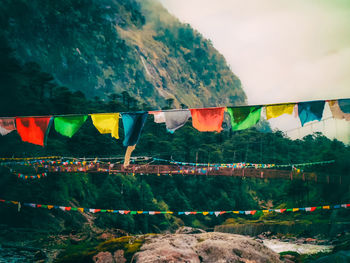 Low angle view of bunting flags against mountain