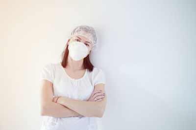 Portrait of woman standing against white background