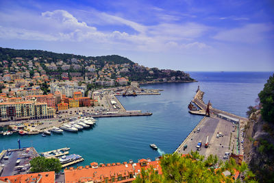 High angle view of townscape by sea against sky