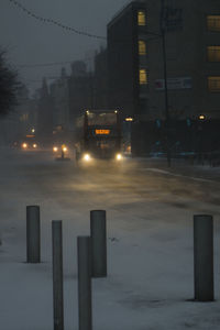 Illuminated city street during winter at night