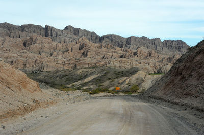 Road amidst mountains against sky