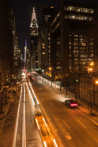 Traffic light trails on road in city at night