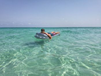 Man surfing in sea against sky