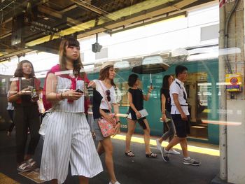 Portrait of young woman sitting on bench