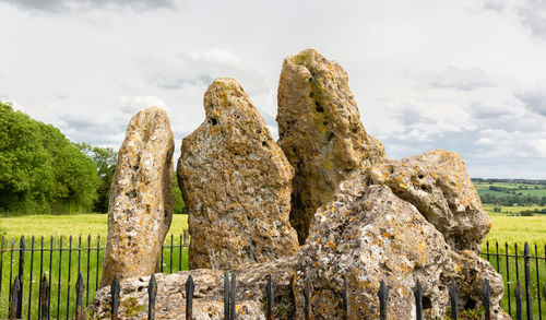 Close-up of rocks on field against sky