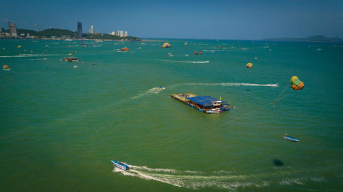 High angle view of people sailing on sea against clear sky