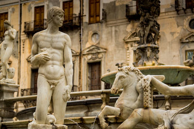 Statue against historic building