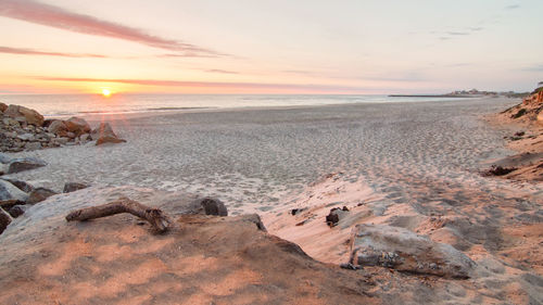 Scenic view of beach against sky during sunset