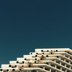 Low angle view of built structure against clear blue sky