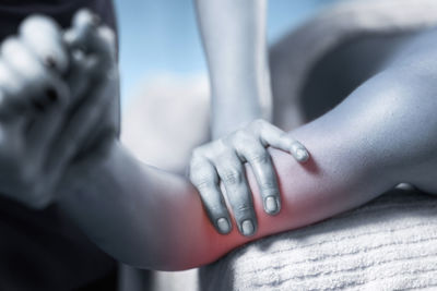 Cropped hands massaging woman at spa