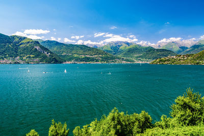 Scenic view of sea and mountains against sky