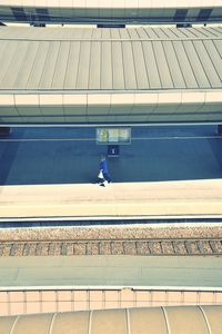 High angle view of man walking on railroad station platform