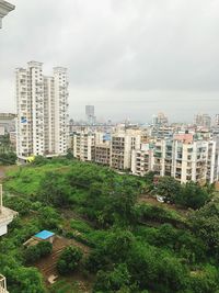 High angle view of trees and buildings against sky