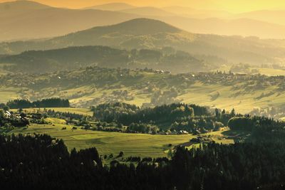 Scenic view of agricultural field against sky during sunset