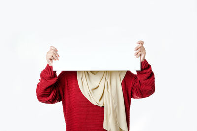 Person holding red umbrella against white background