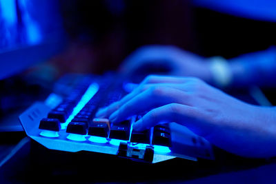 Close-up of hand of woman using computer