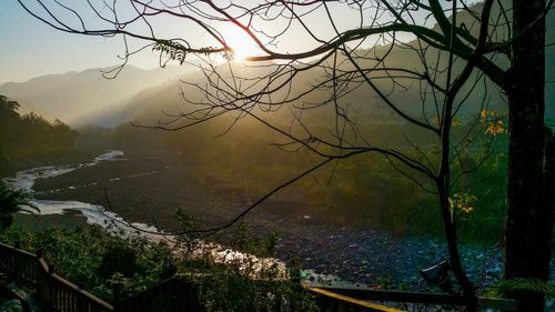 High angle view of river by mountains during sunset